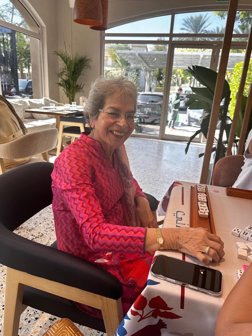 Smiling player practicing Mahjong with guidance