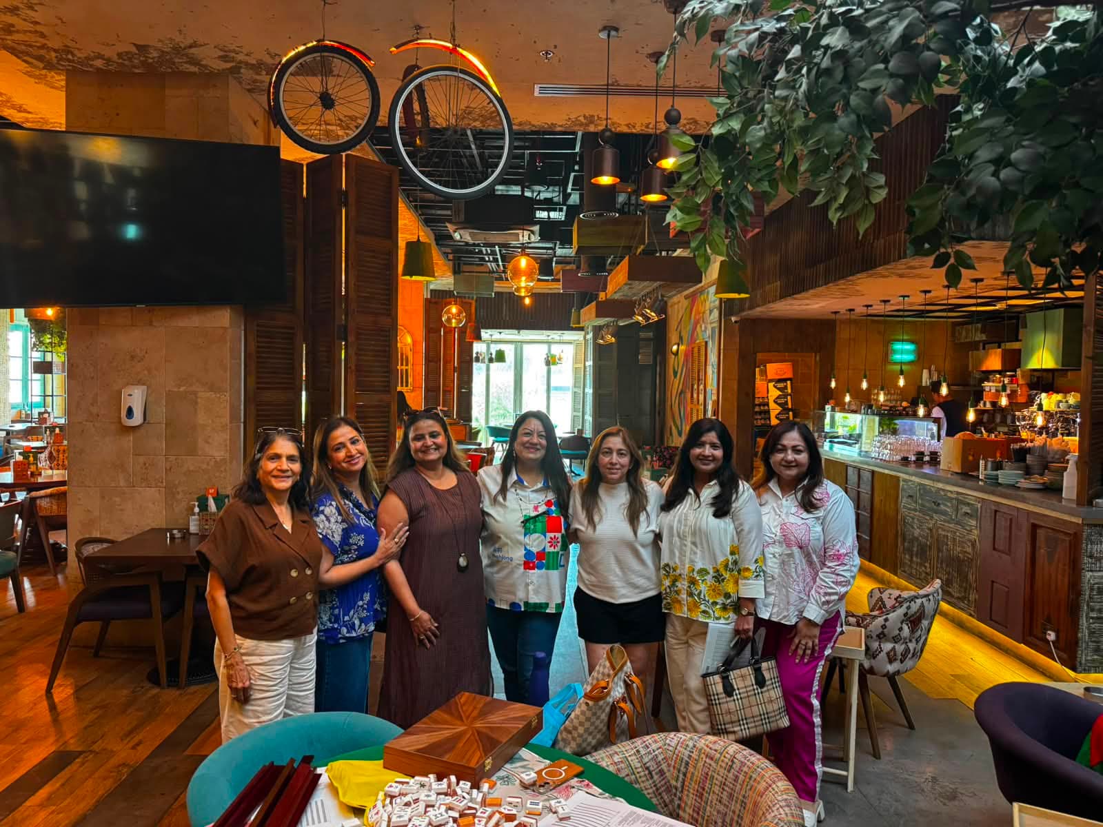 Mahjong World Dubai players standing together by a cafe table