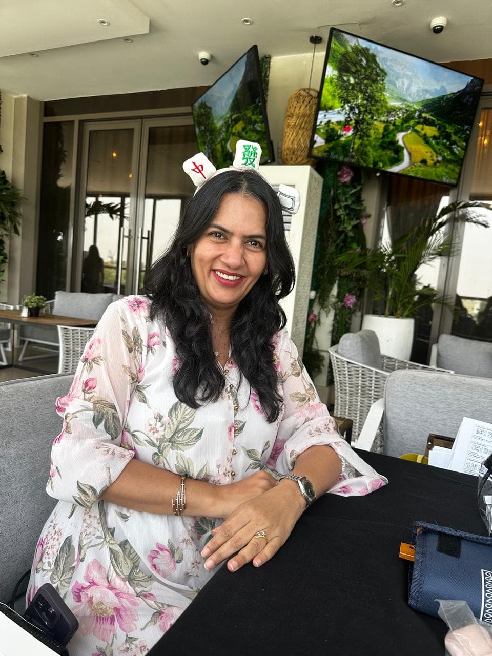 Neha Bali smiling at a Mahjong cafe table