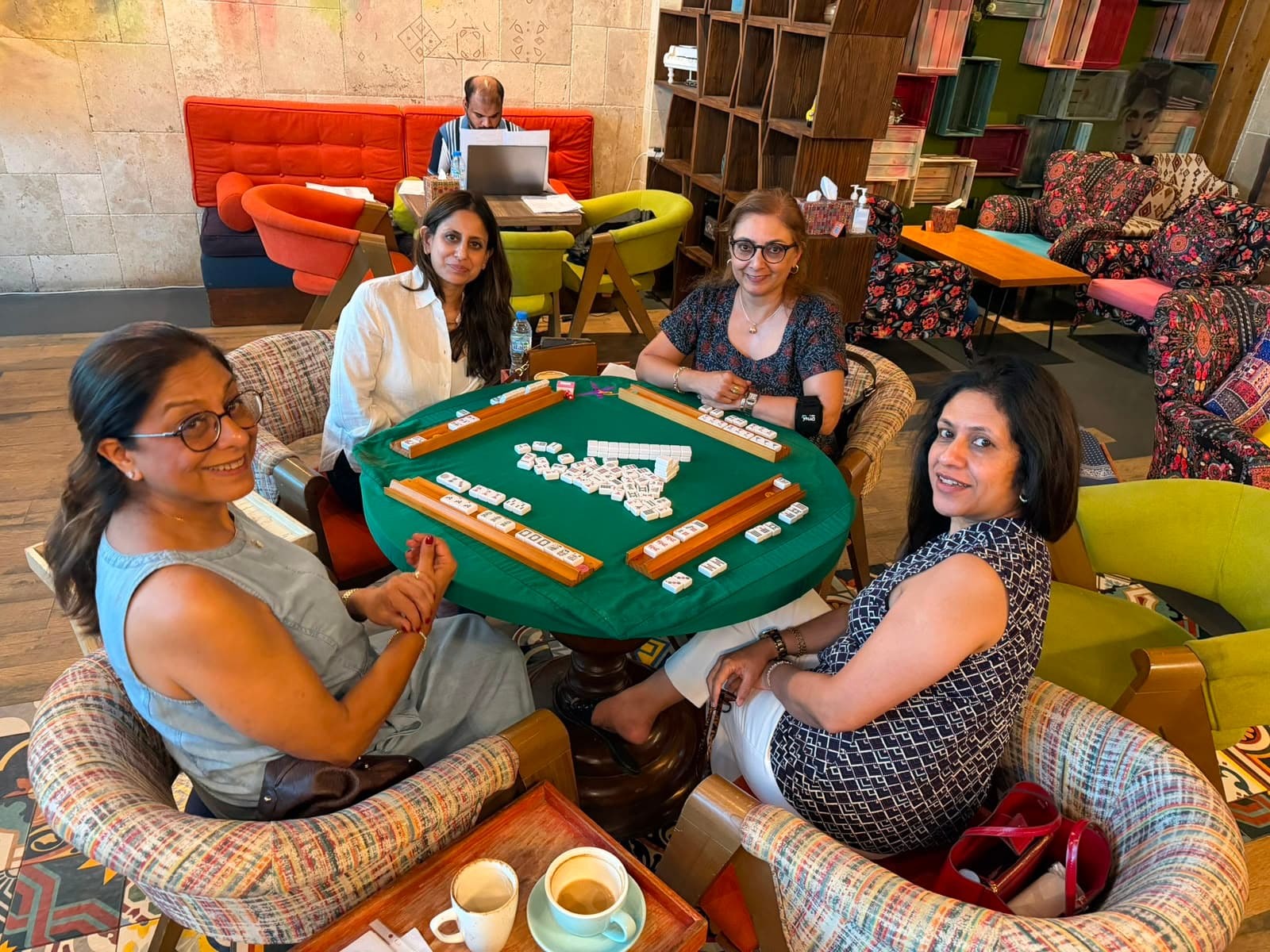 Mahjong regulars playing around a cafe table in Dubai