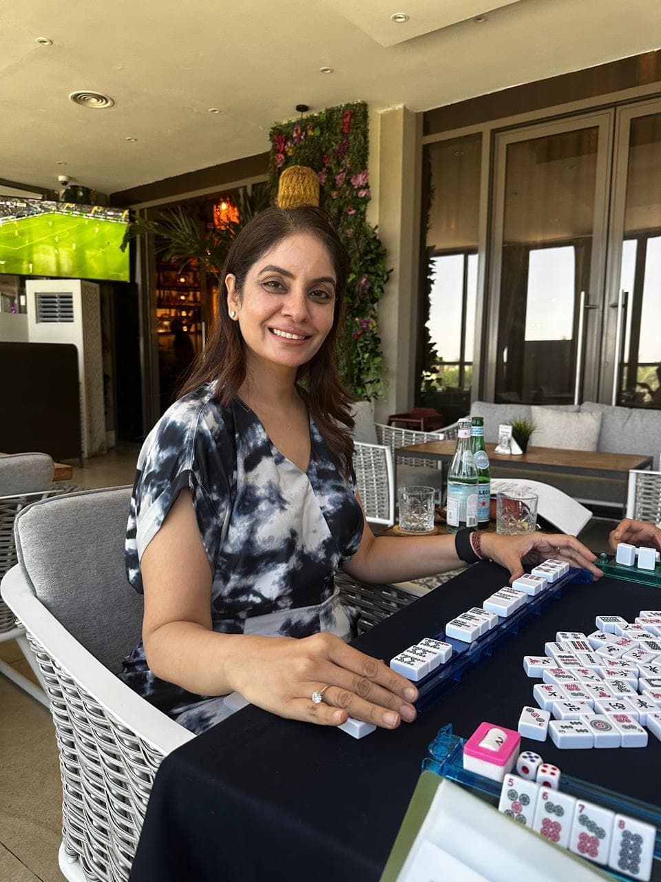 Student seated by a Mahjong rack during open play