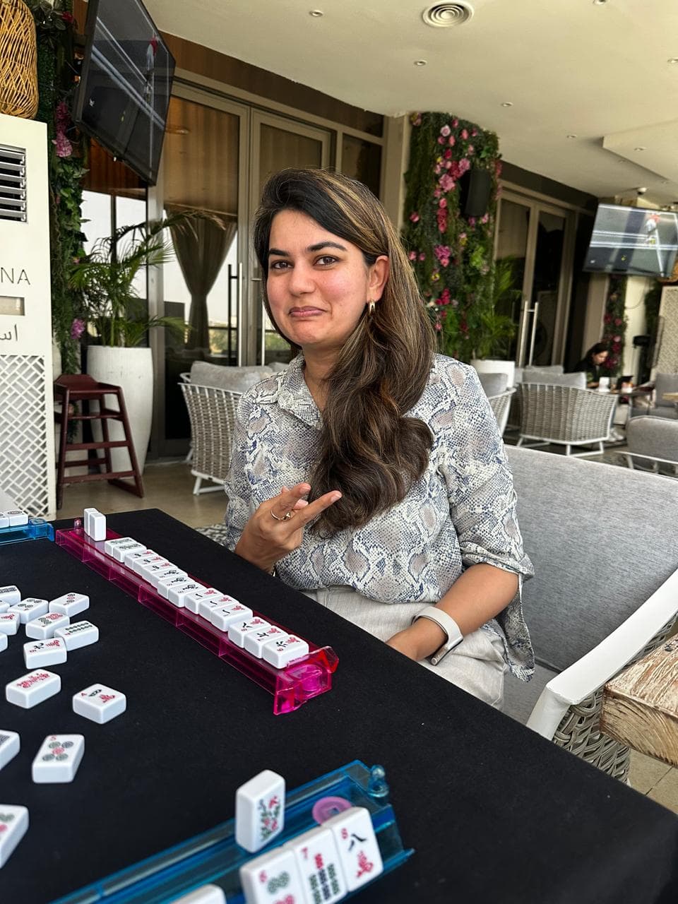 Student learning Mahjong at a Dubai beginner class