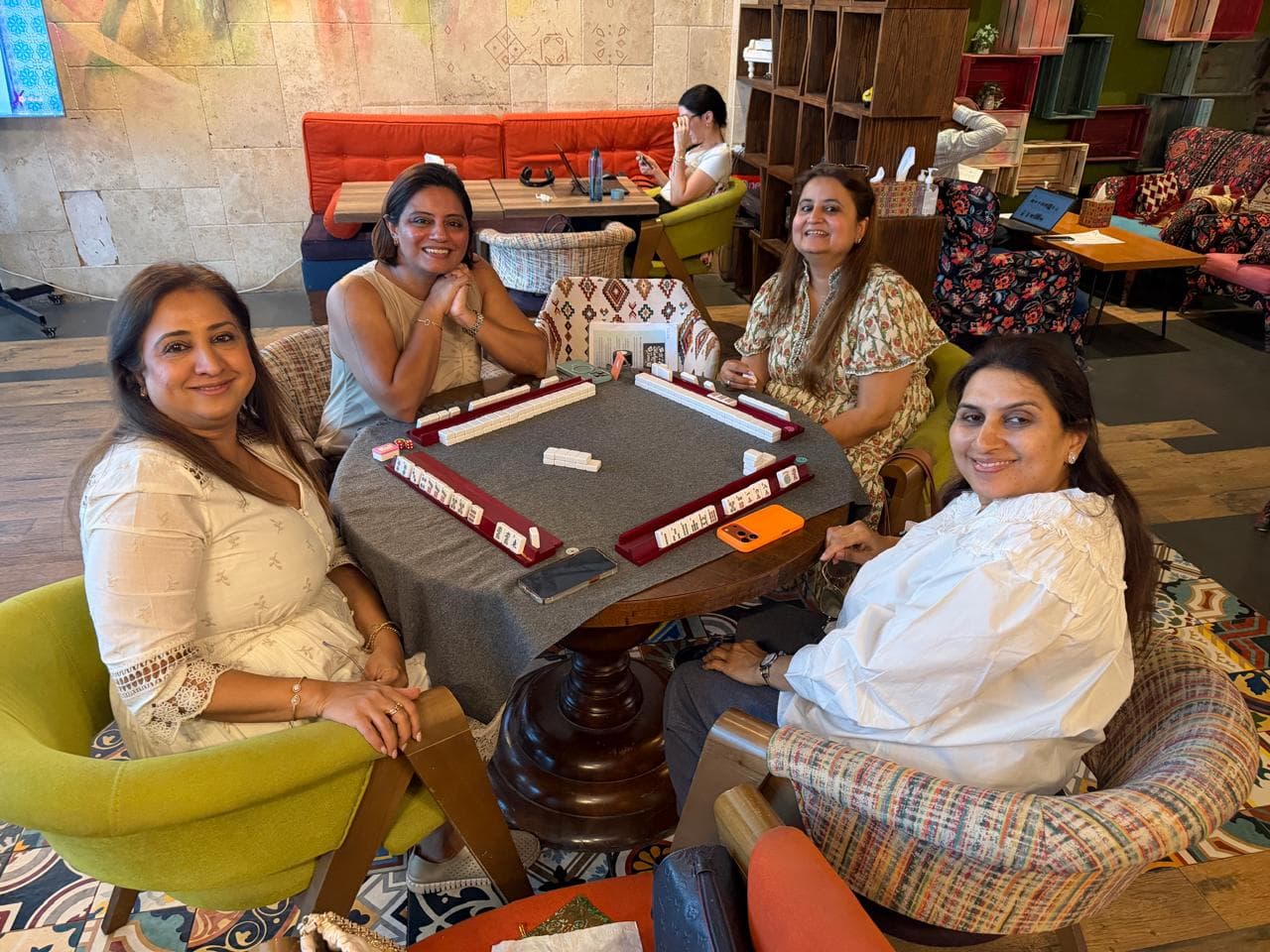 Mahjong table set beside a bright Dubai cafe window