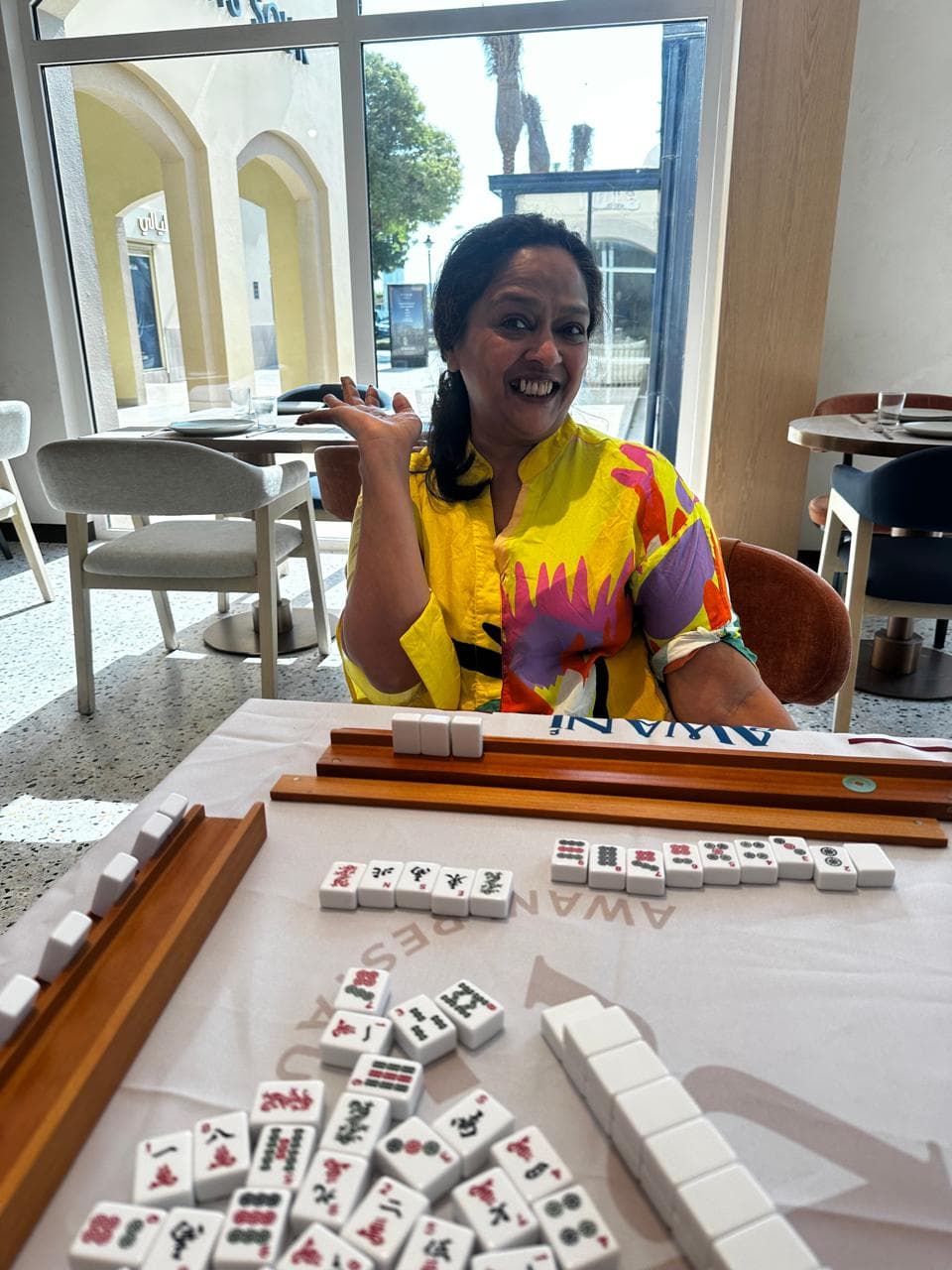 Mahjong player looking at a rack of tiles