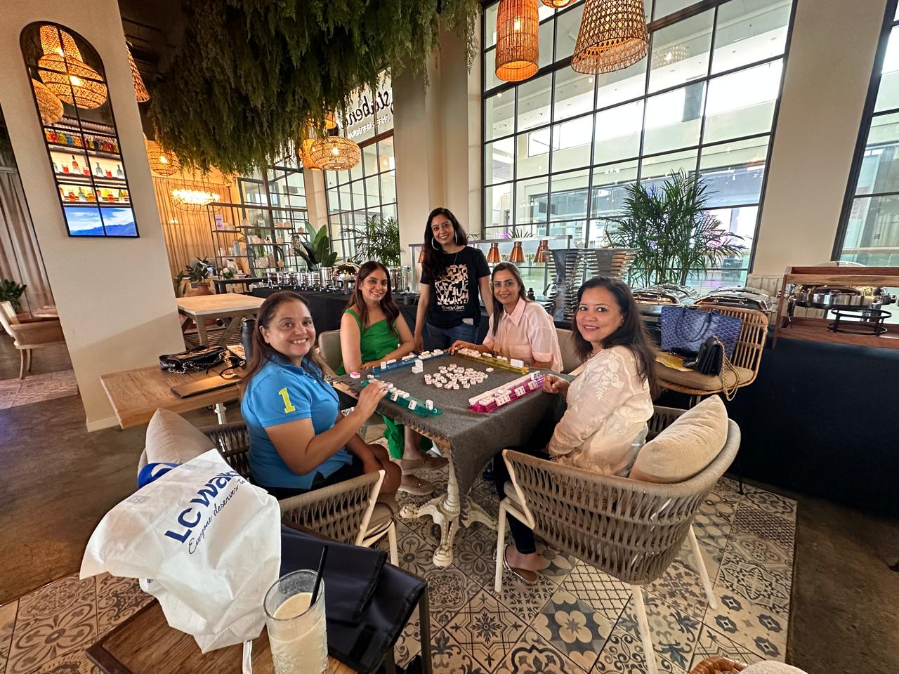 Dubai Mahjong players gathered around a social table
