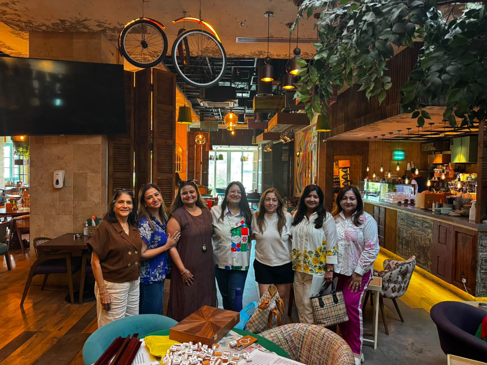 Mahjong World Dubai players standing together by a cafe table