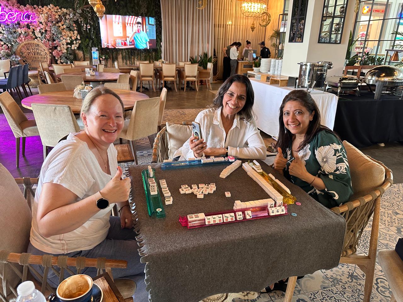Mahjong World Club players at a Dubai table