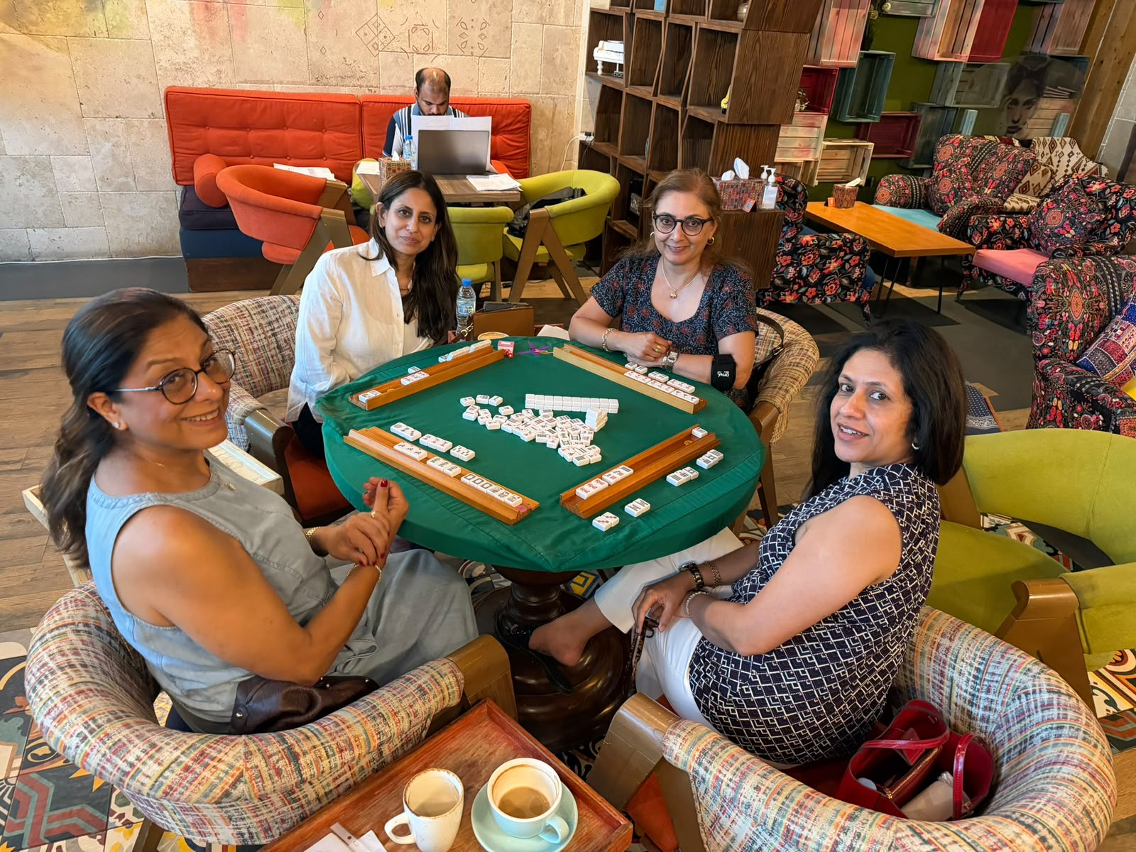 Mahjong regulars playing around a cafe table in Dubai