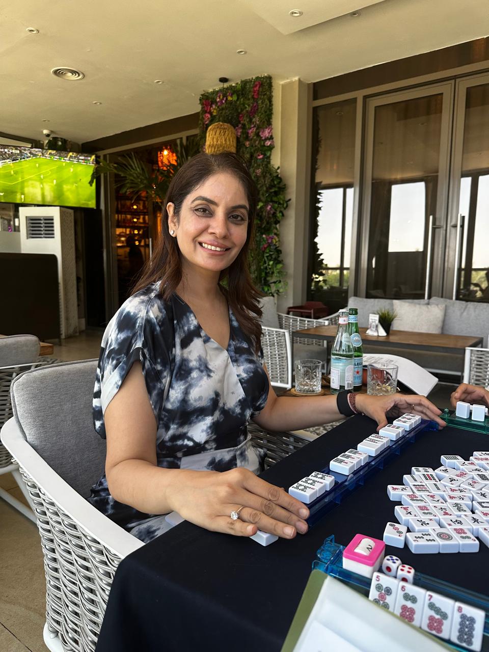 Student seated by a Mahjong rack during open play